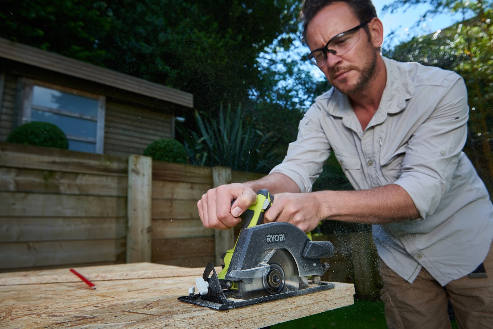 Man using power tool to grind wooden surface